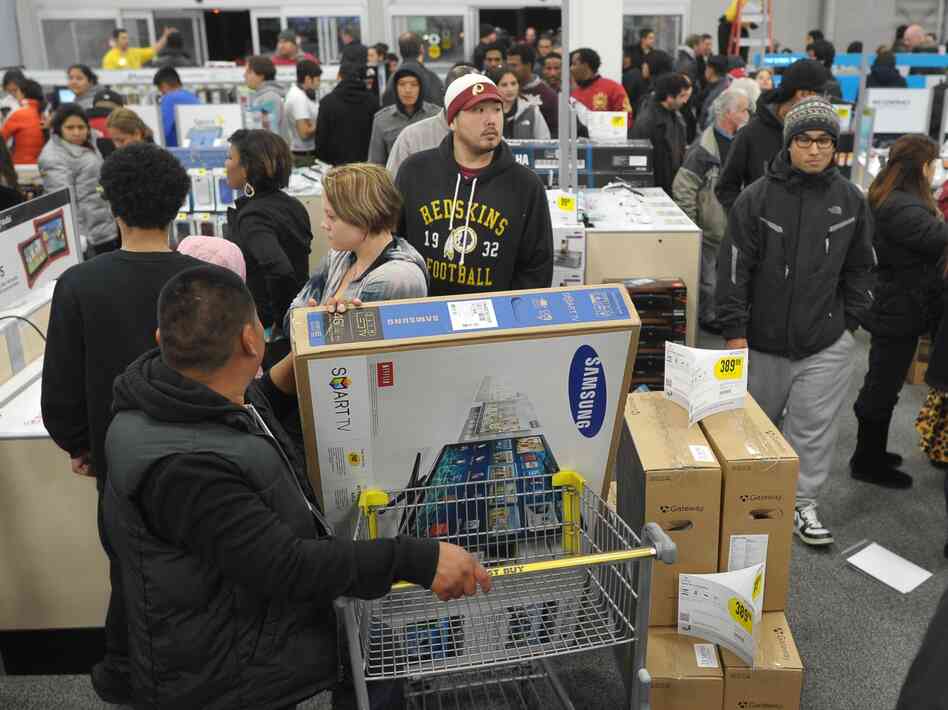 Shoppers line up in a Best Buy store in Rockville, Md., during a Black Friday sale. Thanksgiving weekend sales jumped nearly 13 percent from last year, the National Retail Federation says.