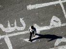 An Egyptian man walks over a graffiti reading "Morsi Go" at Egypt's landmark Tahrir square in Cairo. An Egyptian man walks over a graffiti reading "Morsi Go" at Egypt's landmark Tahrir square in Cairo.