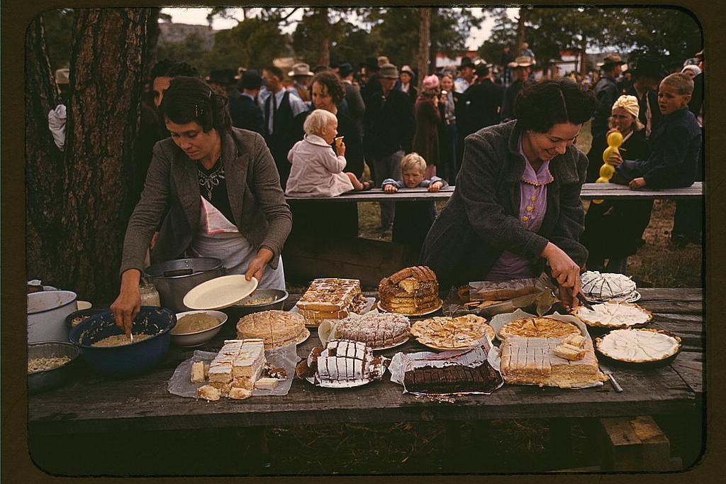 Cutting pies and cakes at a barbecue dinner, 1940