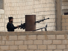 A Syrian rebel fighter is shown in the northeastern Syrian border town of Ras al-Ayn on Nov. 11, several days after the rebels captured it. The rebel takeover has created friction with the town's Kurdish population. A Syrian rebel fighter is shown in the northeastern Syrian border town of Ras al-Ayn on Nov. 11, several days after the rebels captured it. The rebel takeover has created friction with the town's Kurdish population.