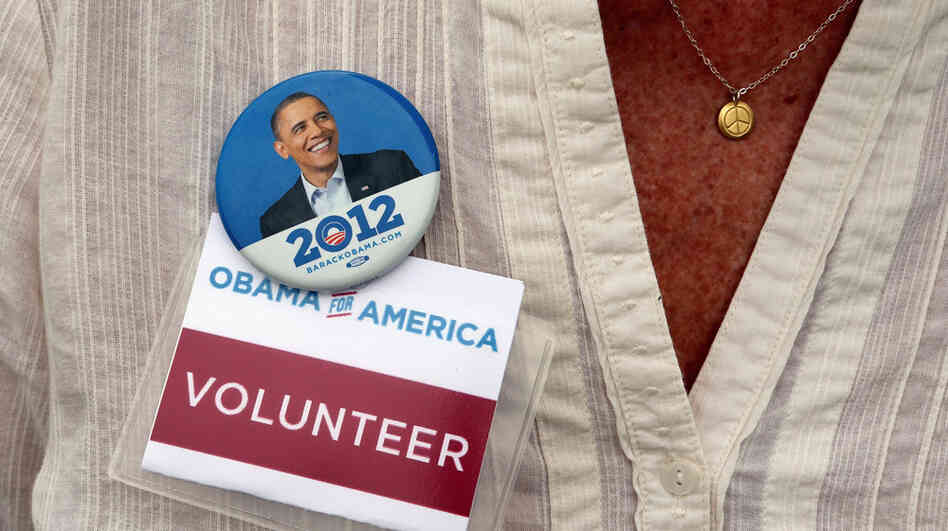 A campaign volunteer wears a button as President Obama speaks at a campaign event in Maumee, Ohio. Now that the election is over, the Obama team is trying to keep supporters engaged in the president's second term.