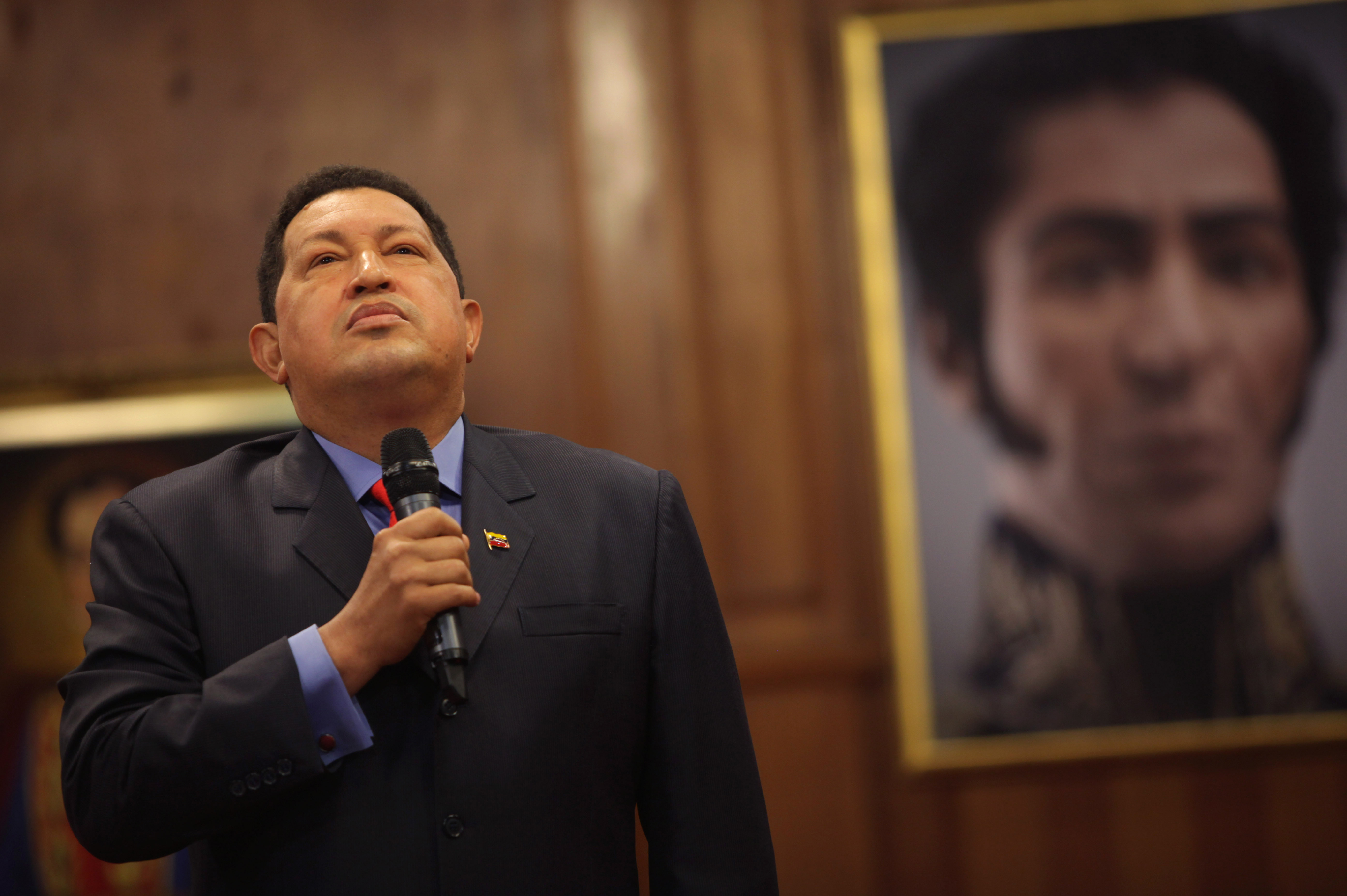 Standing next to a portrait of independence hero Simon Bolivar, Venezuelan President Hugo Chavez speaks during a press conference at Miraflores Palace in the capital, Caracas, in October 2012.