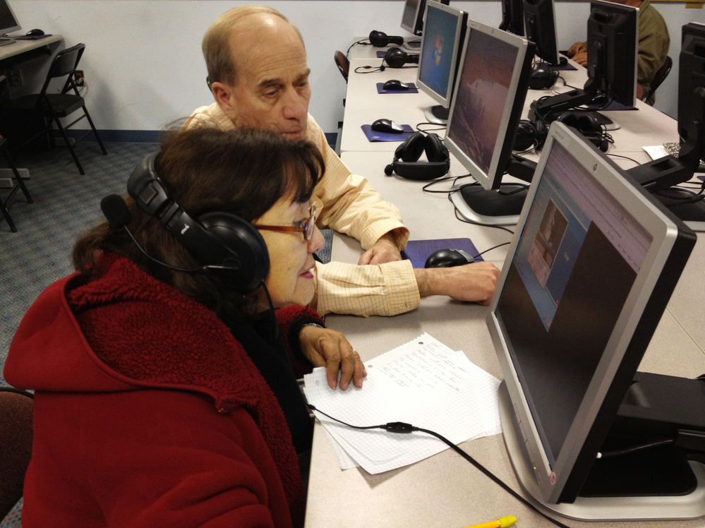Donald Desmond teaches Abdesa Bustina to use a computer at the New Haven Adult and Continuing Education Center. The new GED will be offered only on computer, but many students here don't know how to use one.