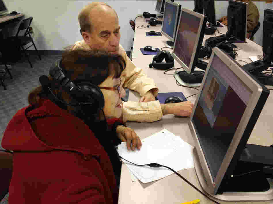 Donald Desmond teaches Abdesa Bustina to use a computer at the New Haven Adult and Continuing Education Center. The new GED will be offered only on computer, but many students here don't know how to use one.