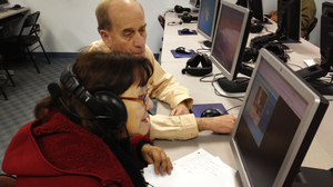 Donald Desmond teaches Abdesa Bustina to use a computer at the New Haven Adult and Continuing Education Center. The new GED will be offered only on computer, but many students here don't know how to use one.