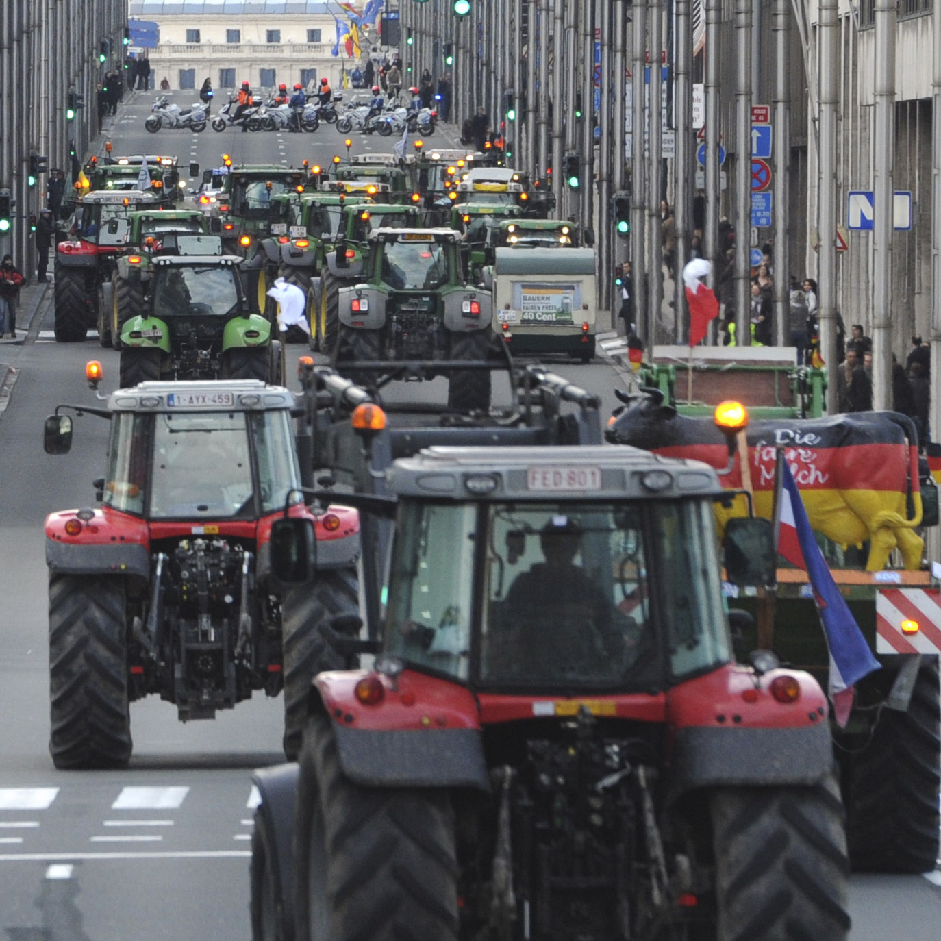 European milk farmers drive their tractors down a main thoroughfare in the European Quarter of Brussels on Monday.