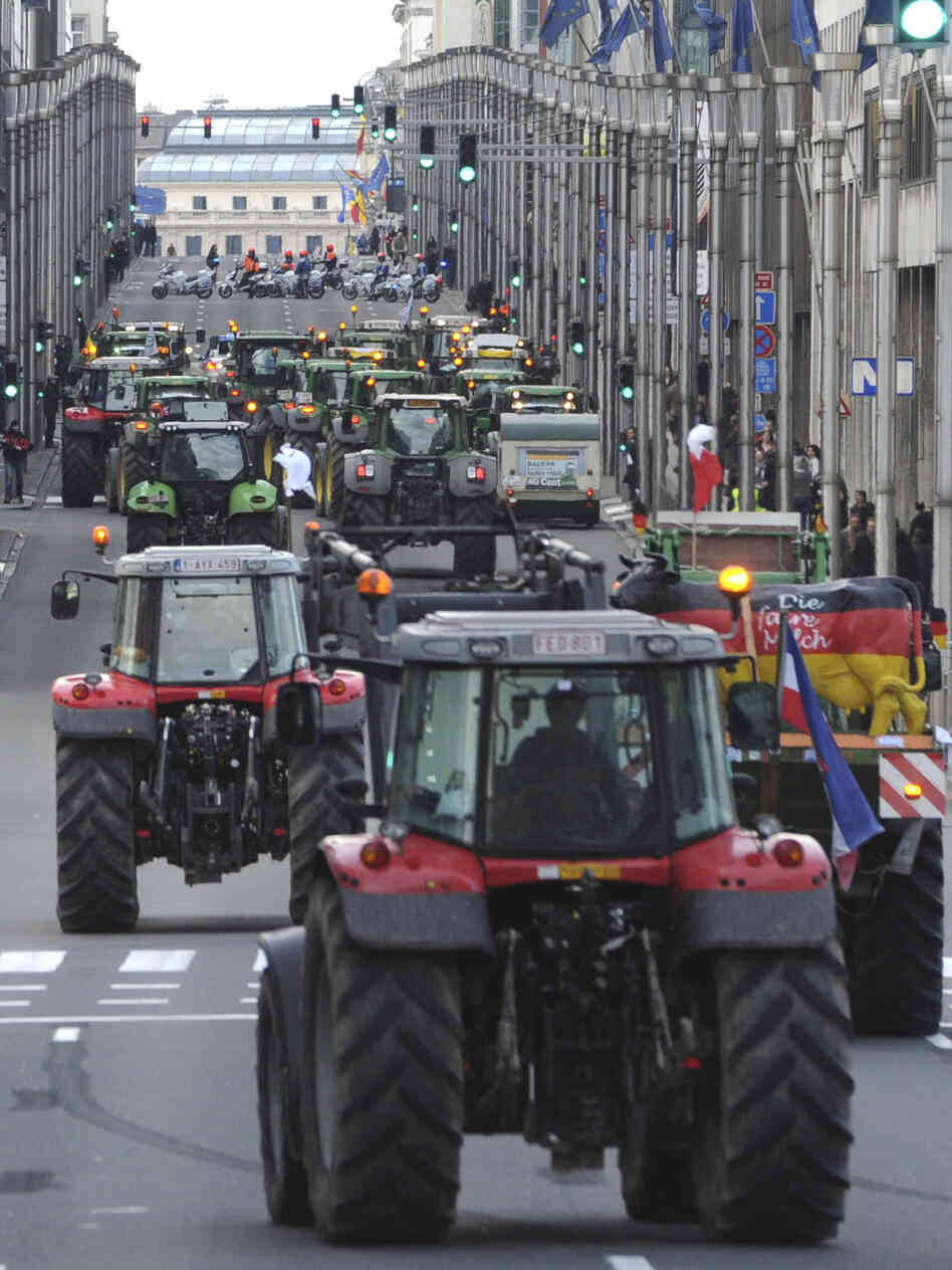 European milk farmers drive their tractors down a main thoroughfare in the European Quarter of Brussels on Monday.
