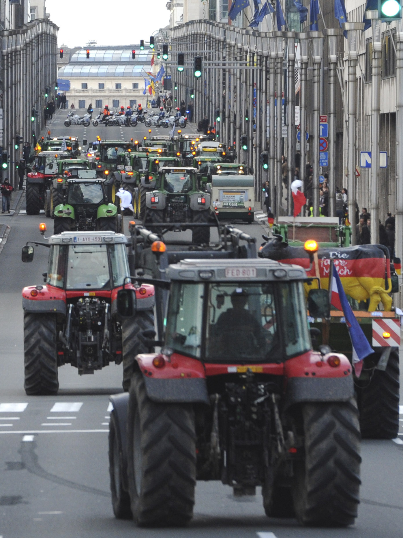European milk farmers drive their tractors down a main thoroughfare in the European Quarter of Brussels on Monday. European milk farmers drive their tractors down a main thoroughfare in the European Quarter of Brussels on Monday.