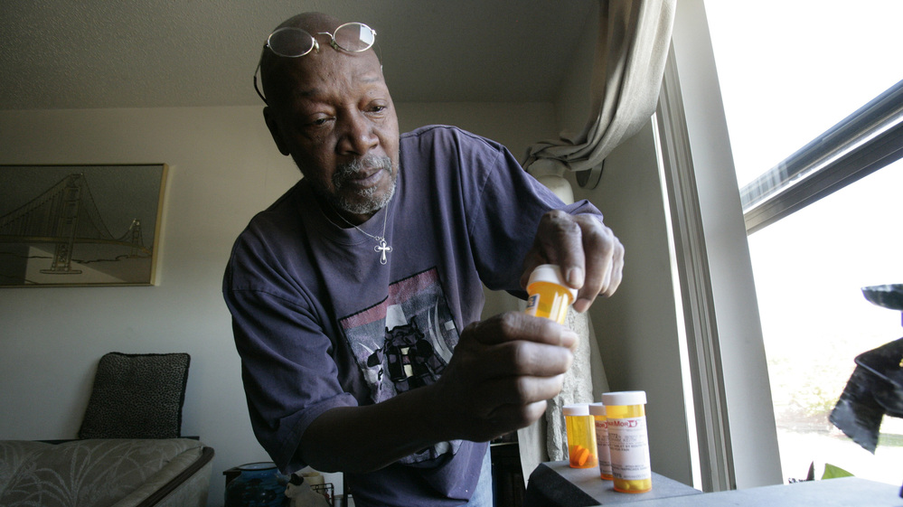 Keith Gresham, 65, lines up four medications he takes at his home in Detroit in 2011. The self-employed painter was without health insurance for about a decade and was happy to finally turn 65 last year so he could qualify for Medicare.
