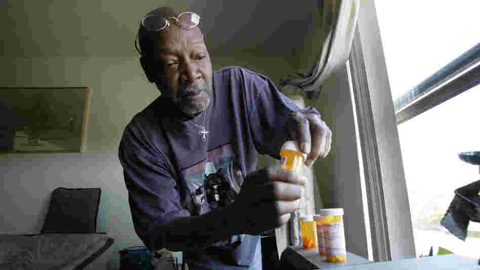 Keith Gresham, 65, lines up four medications he takes at his home in Detroit in 2011. The self-employed painter was without health insurance for about a decade and was happy to finally turn 65 last year so he could qualify for Medicare.