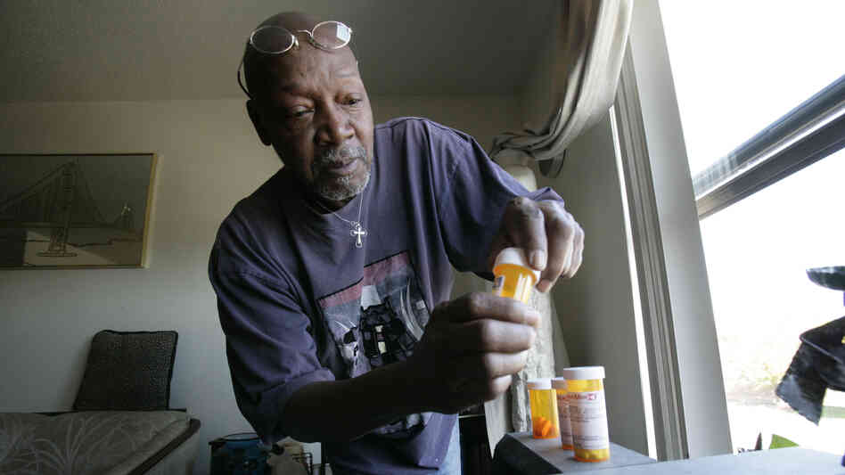 Keith Gresham, 65, lines up four medications he takes at his home in Detroit in 2011. The self-employed painter was without health insurance for about a decade and was happy to finally turn 65 last year so he could qualify for Medicare.