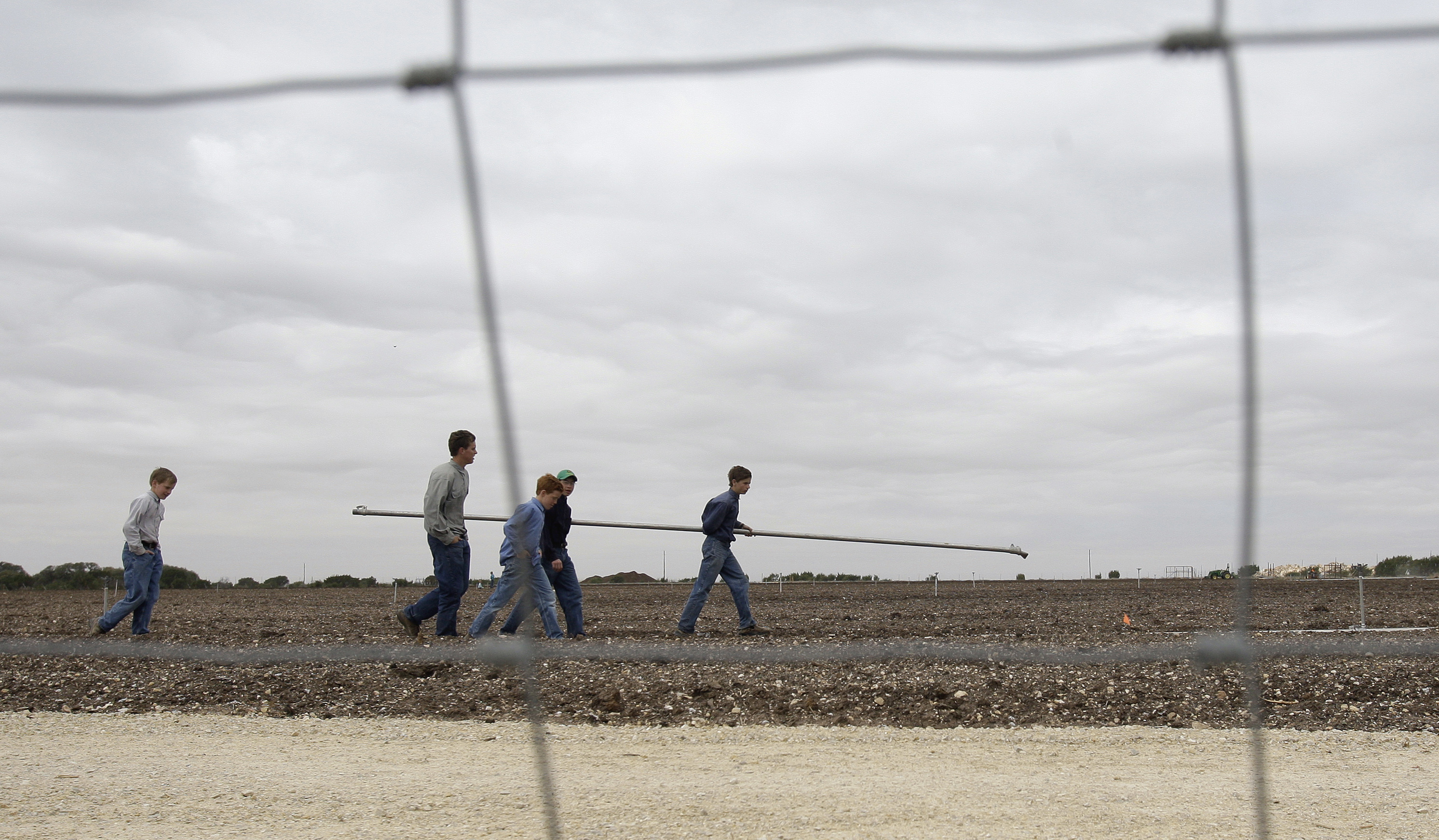 Boys walk through a potato field at the Yearning for Zion Ranch in Eldorado, Texas, in 2009. Boys walk through a potato field at the Yearning for Zion Ranch in Eldorado, Texas, in 2009.