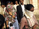 Shaheen Dhada (left) and Renu Srinivasan leave court in Mumbai on Nov. 19. Dhada was arrested for a Facebook post questioning the shutdown of Mumbai for the funeral of a powerful politician; Srinivasan was arrested for "liking" the post. Shaheen Dhada (left) and Renu Srinivasan leave court in Mumbai on Nov. 19. Dhada was arrested for a Facebook post questioning the shutdown of Mumbai for the funeral of a powerful politician; Srinivasan was arrested for "liking" the post.