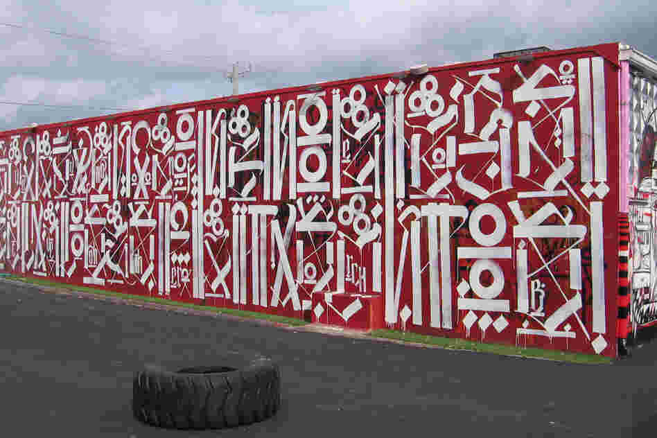 Los Angeles artist RETNA developed his own alphabet from gang writing and calligraphy. The top line on this RETNA mural reads "sacred dance of memories."