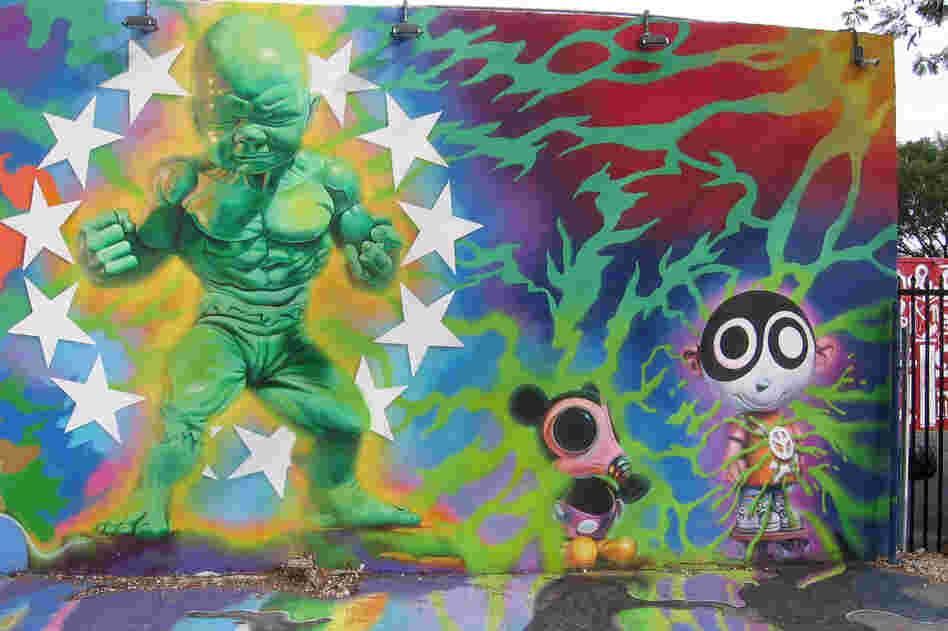 New York artist Ron English's mural appears to bleed off the wall onto the pavement.