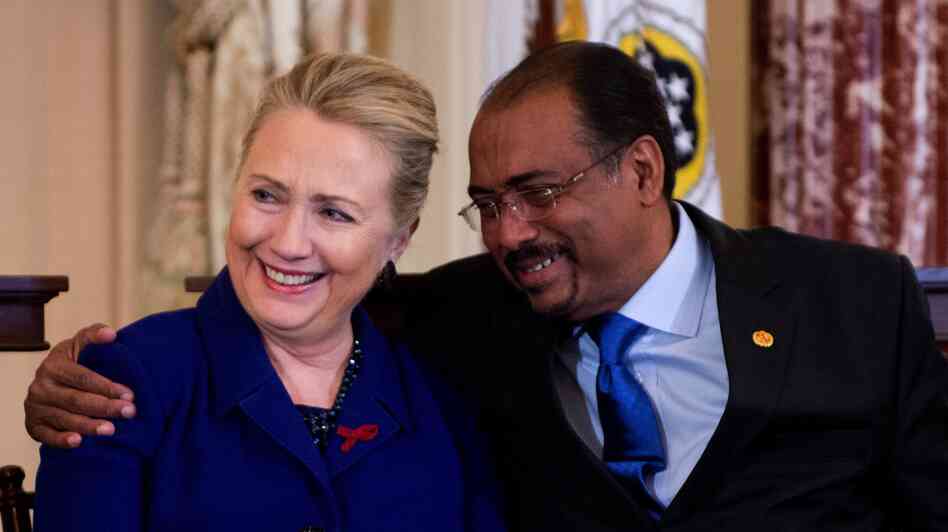 United Nations Aids Executive Director Michel Sibide hugs Secretary of State Hillary Clinton after they they presented the a road map for stopping HIV around the world.