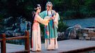 A garden serves as the stage in the opera. A garden serves as the stage in the opera.