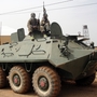 Fighters of the Islamist group, the Movement for Oneness and Jihad in West Africa guard a tank abandoned by the Malian army on Aug. 7.