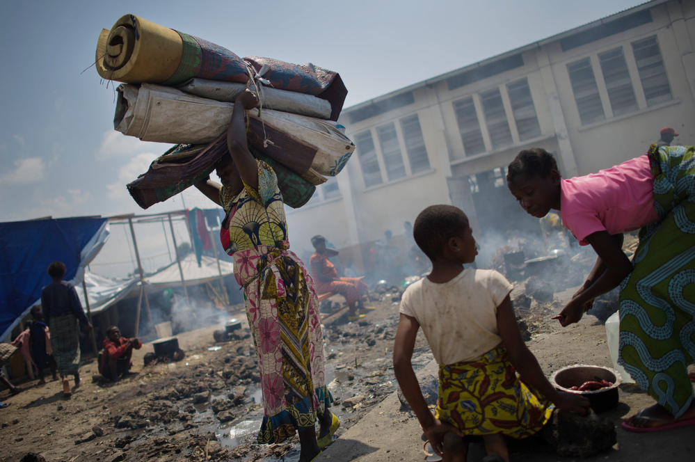A displaced Congolese woman carries her belongings in the grounds of a religious organisation on the outskirts of Goma in the east of the Democratic Republic of the Congo, earlier this week.