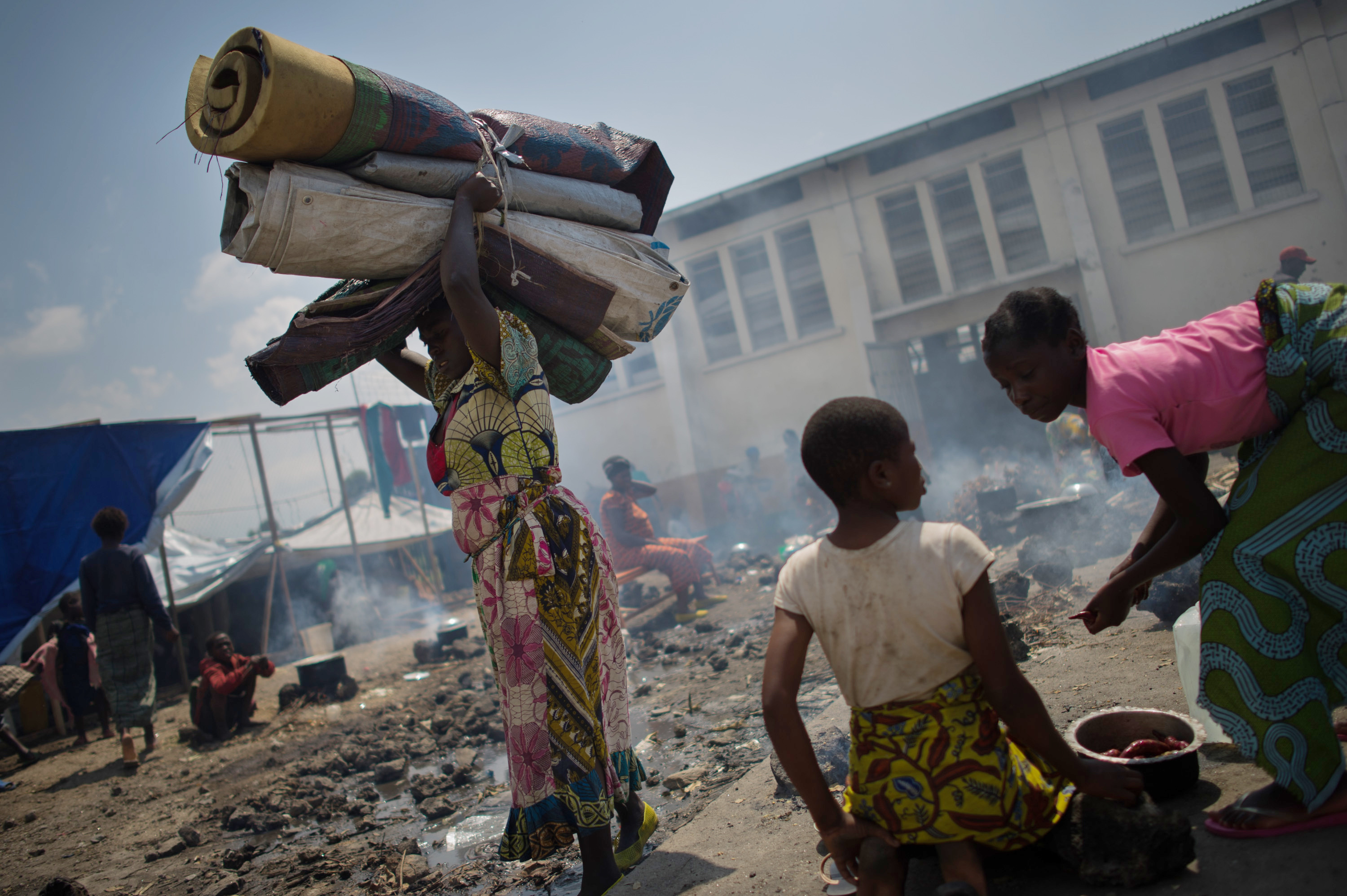 A displaced Congolese woman carries her belongings in the grounds of a religious organisation on the outskirts of Goma in the east of the Democratic Republic of the Congo, earlier this week. A displaced Congolese woman carries her belongings in the grounds of a religious organisation on the outskirts of Goma in the east of the Democratic Republic of the Congo, earlier this week.