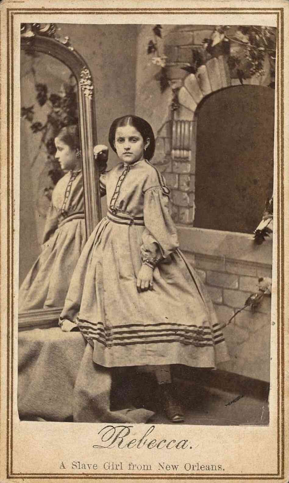 Rebecca Huler's poses next to a mirror with reflects her profile.