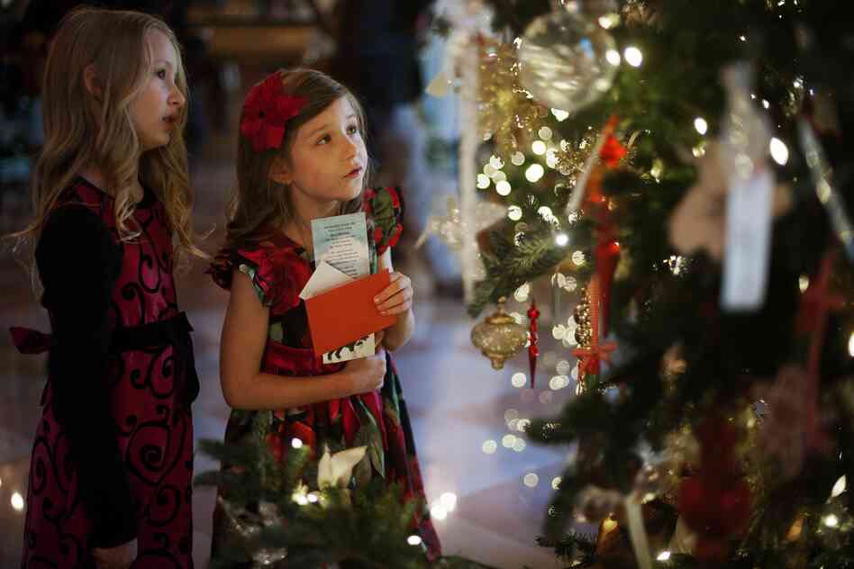 Lauren Rae (left) and Olivia Marlow look at the ornaments in the Grand Foyer during the first viewing of the White House 2012 holiday decorations in Washington, D.C., on Wednesday. This year's theme is "Joy to All."