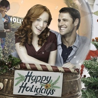 Why yes, this is a promotional image for a real holiday Hallmark movie called Annie Claus Is Comin' To Town. That's Annie Claus, Santa's daughter, inside the snow globe being stared at by her father.