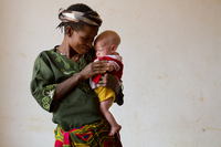 Helen Sekalima, 40, with her baby, Jessica, two months old, at the Kabanga Protectorate Center. Of Helen's nine children, three of them have albinism.