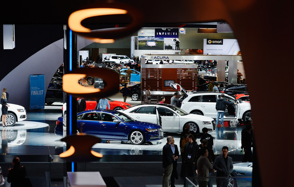 Attendees walk through the Los Angeles Convention Center floor during the L.A. Auto show on Nov. 29. Technology is taking the idea of working from the road to a whole new level.