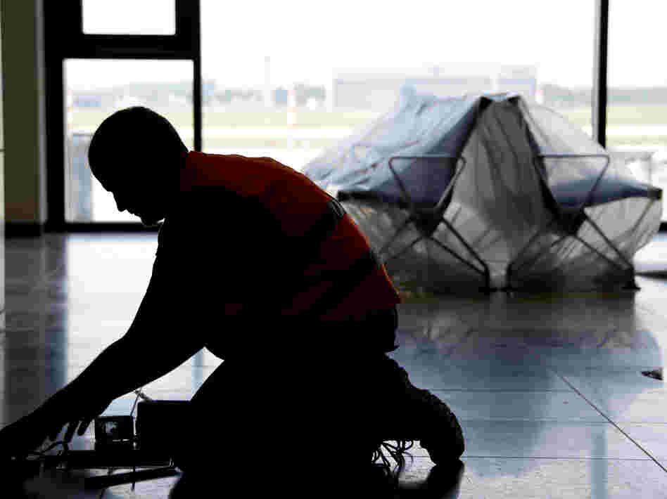 A carpenter works in the unfinished departure hall of the airport on Sept. 11.