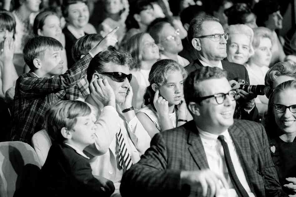 "When The Beatles returned to America in August, 1965 ... I got one of my favorites. Walking the aisles, one audience member caught my eye: an older man sitting with his fingers plugged in his ears to mute the high-pitched squeals. As I moved in for this terrific shot, I got a closer look and realized I was photographing the legendary composer and conductor Leonard Bernstein."