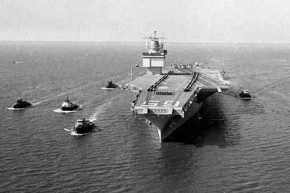 The world's largest ship, the nuclear-powered aircraft carrier USS Enterprise, is shown leaving Newport News, Va., with a five-tugboat escort during initial sea trials in 1961.