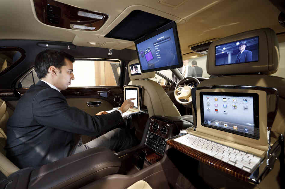 The 2013 Bentley Mulsanne features drop-down iPad workstations. More cars are being outfitted to operate as mobile offices.