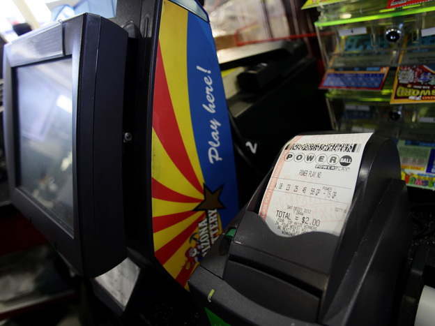 A Powerball lottery ticket sits in the machine at the 4 Sons Food Store and Chevron gas station which sold one of two winning Powerball lottery tickets in Fountain Hills, Ariz.