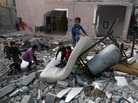 Palestinian children play in the rubble of a house that was hit by an Israeli strike during Israel's recent military offensive in the Gaza Strip Saturday. Palestinian children play in the rubble of a house that was hit by an Israeli strike during Israel's recent military offensive in the Gaza Strip Saturday.