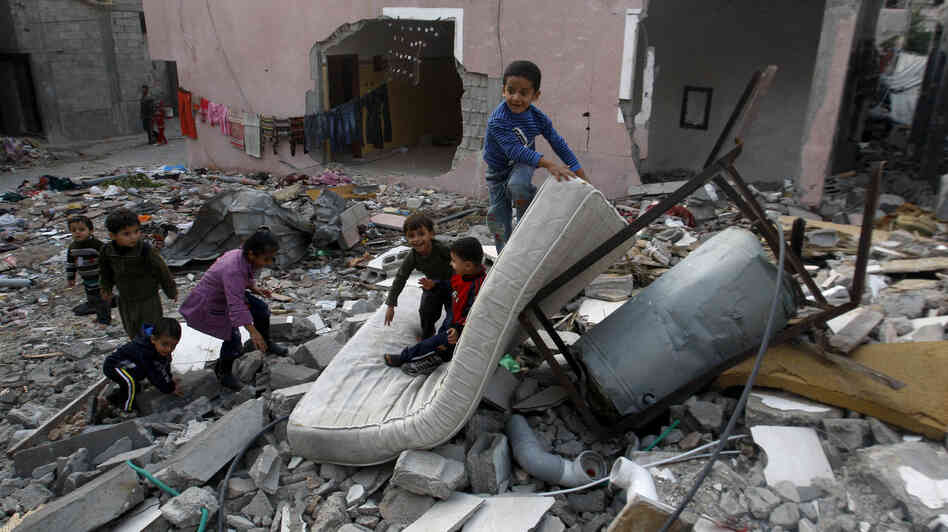 Palestinian children play in the rubble of a house that was hit by an Israeli strike during Israel's recent military offensive in the Gaza Strip Saturday.