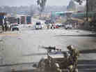 Afghan security forces block the road where Taliban suicide bombers attacked a joint U.S.- Afghan air base in Jalalabad, east of Kabul, Afghanistan on Sunday. Afghan security forces block the road where Taliban suicide bombers attacked a joint U.S.- Afghan air base in Jalalabad, east of Kabul, Afghanistan on Sunday.