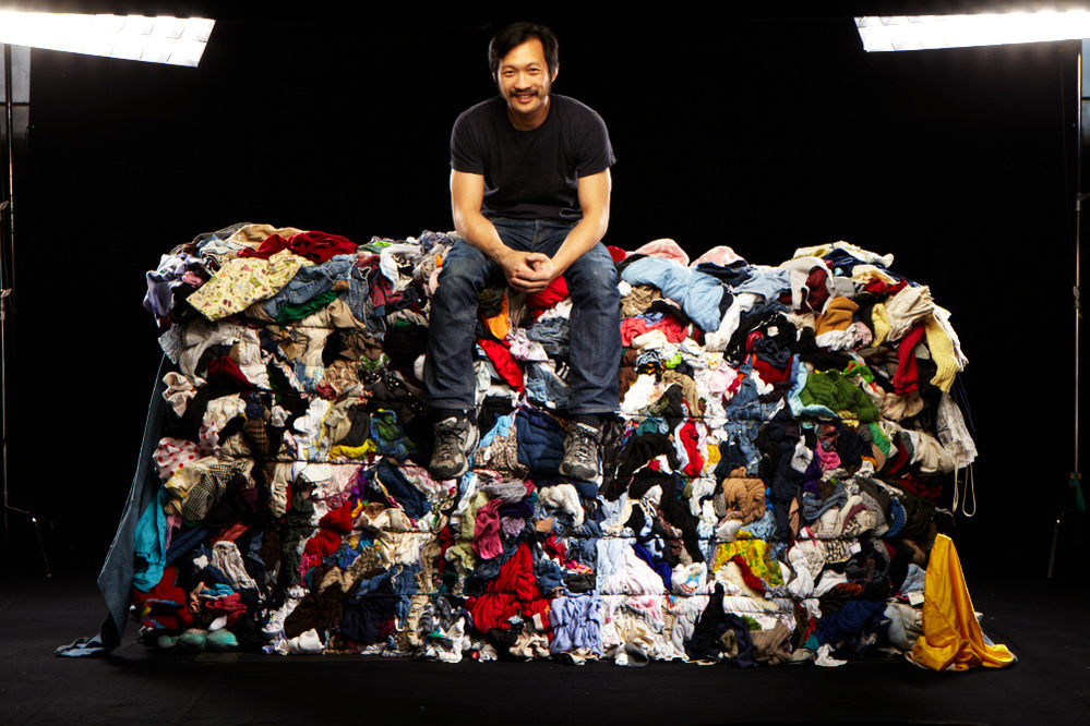 Wesley Law poses atop one of the bales in the Goodwill Outlet store in St. Louis.