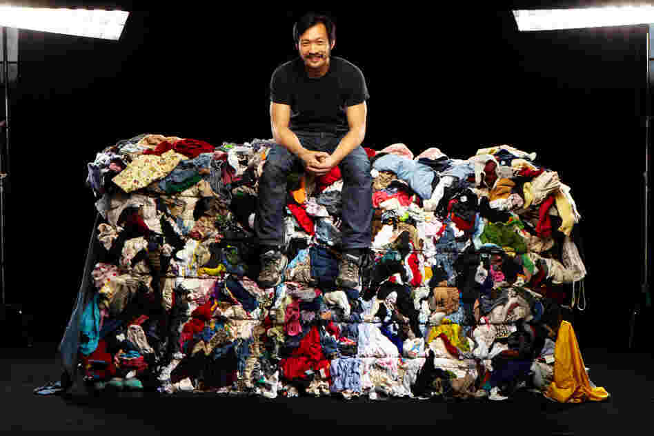Wesley Law poses atop one of the bales in the Goodwill Outlet store in St. Louis.