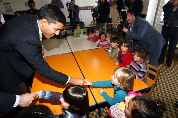Rajiv Shah (left), the head of USAID, speaks with children during a visit at the Oncupinar Syrian refugee camp in Turkey, near the Syrian border, on Nov. 27.