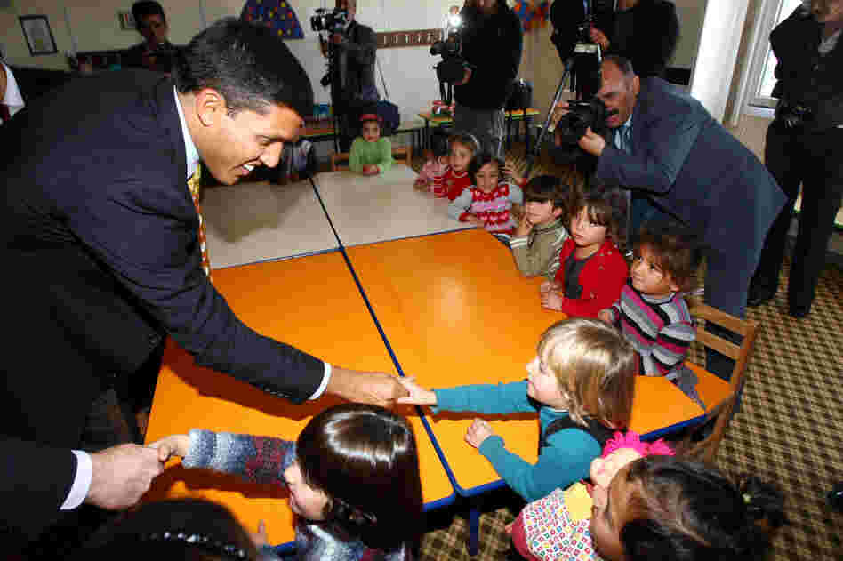 Rajiv Shah (left), the head of USAID, speaks with children during a visit at the Oncupinar Syrian refugee camp in Turkey, near the Syrian border, on Nov. 27.