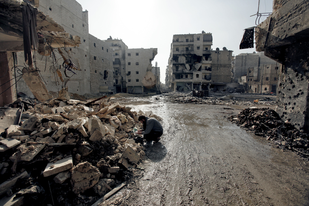 A man is seen in the al-Amirya neighborhood of the city of Aleppo on Sunday. Syrian artillery and aircraft also battered rebel positions in and around Damascus in an operation to secure the capital. A man is seen in the al-Amirya neighborhood of the city of Aleppo on Sunday. Syrian artillery and aircraft also battered rebel positions in and around Damascus in an operation to secure the capital.