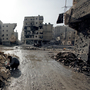 A man is seen in the al-Amirya neighborhood of the city of Aleppo on Sunday. Syrian artillery and aircraft also battered rebel positions in and around Damascus in an operation to secure the capital.