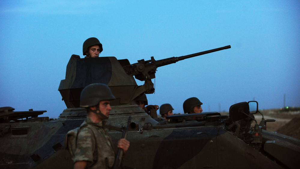 Turkish soldiers stand guard in the town of Akcakale, just across the border from Syria, on Oct. 4. The Turks have often issued stern warnings and retaliated when shooting from the Syrian war has come across their border. But Turkey did not respond to an incident over the weekend.