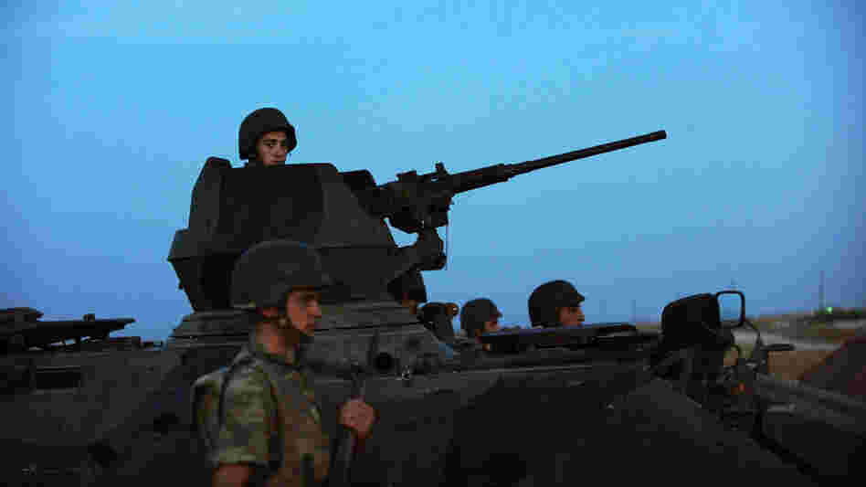 Turkish soldiers stand guard in the town of Akcakale, just across the border from Syria, on Oct. 4. The Turks have often issued stern warnings and retaliated when shooting from the Syrian war has come across their border. But Turkey did not respond to an incident over the weekend.