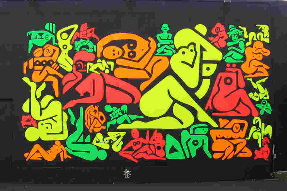 Ryan McGinness' 33 Women uses red, orange, green and yellow DayGlo paint on a black background.