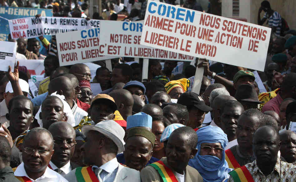 People originally from northern Mali carry signs that call for military action to retake that part of the country, now under the control of Islamist militants. The rally was held in Mali's capital, Bamako, in October. People originally from northern Mali carry signs that call for military action to retake that part of the country, now under the control of Islamist militants. The rally was held in Mali's capital, Bamako, in October.