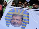 Egyptian protesters hold a banner depicting Morsi as a pharaoh, during a rally expressing opposition to Morsi's decrees, in Cairo, on Nov. 23. Egyptian protesters hold a banner depicting Morsi as a pharaoh, during a rally expressing opposition to Morsi's decrees, in Cairo, on Nov. 23.