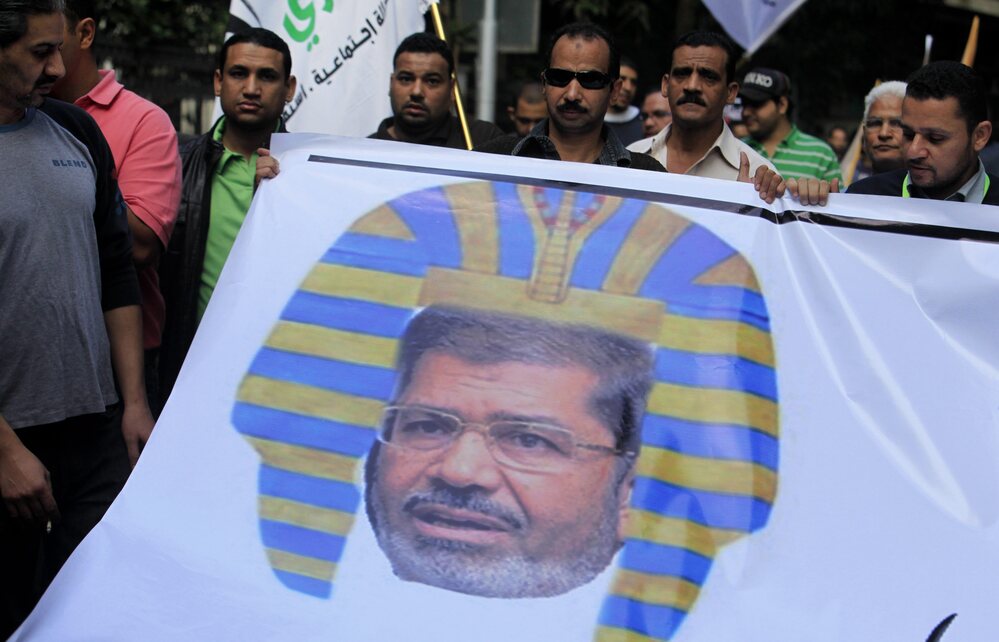 Egyptian protesters hold a banner depicting Morsi as a pharaoh, during a rally expressing opposition to Morsi's decrees, in Cairo, on Nov. 23.