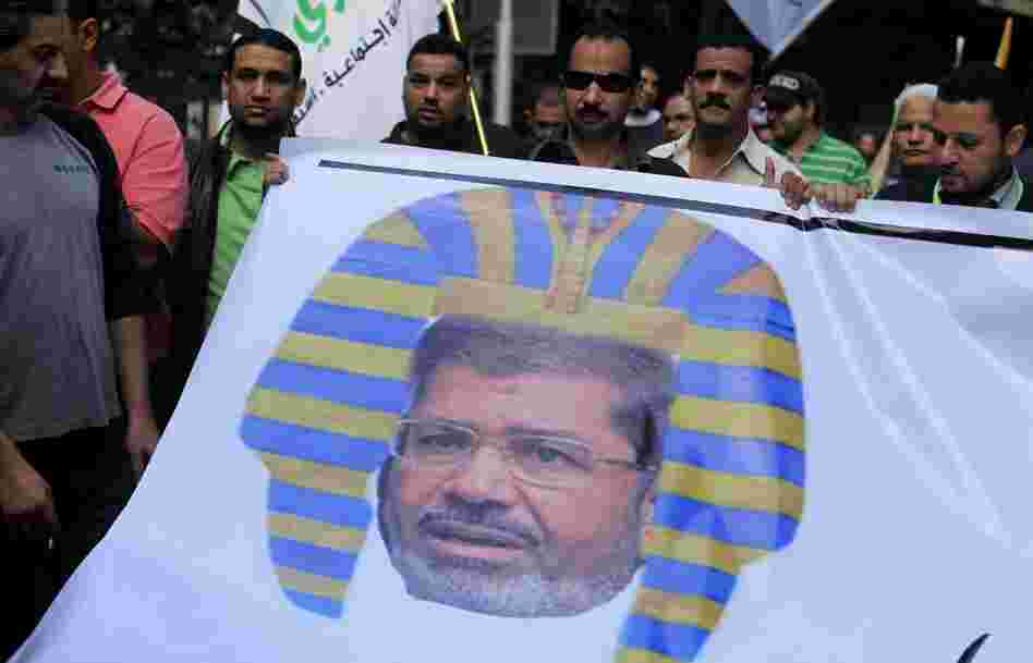 Egyptian protesters hold a banner depicting Morsi as a pharaoh, during a rally expressing opposition to Morsi's decrees, in Cairo, on Nov. 23.